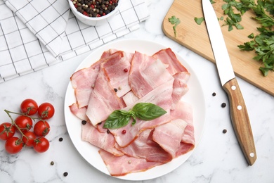 Photo of Flat lay composition with sliced raw bacon on white marble table