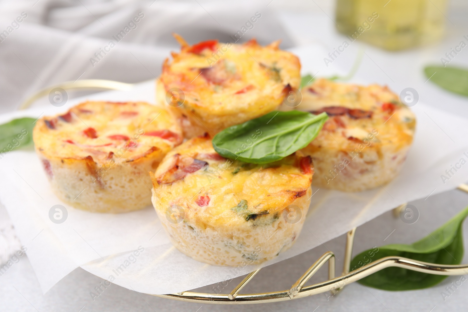 Photo of Freshly baked bacon and egg muffins with cheese on table, closeup