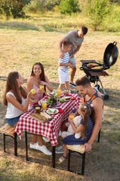 Happy families with little children having picnic in park