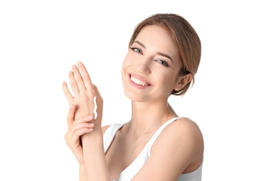 Photo of Young woman applying hand cream on white background