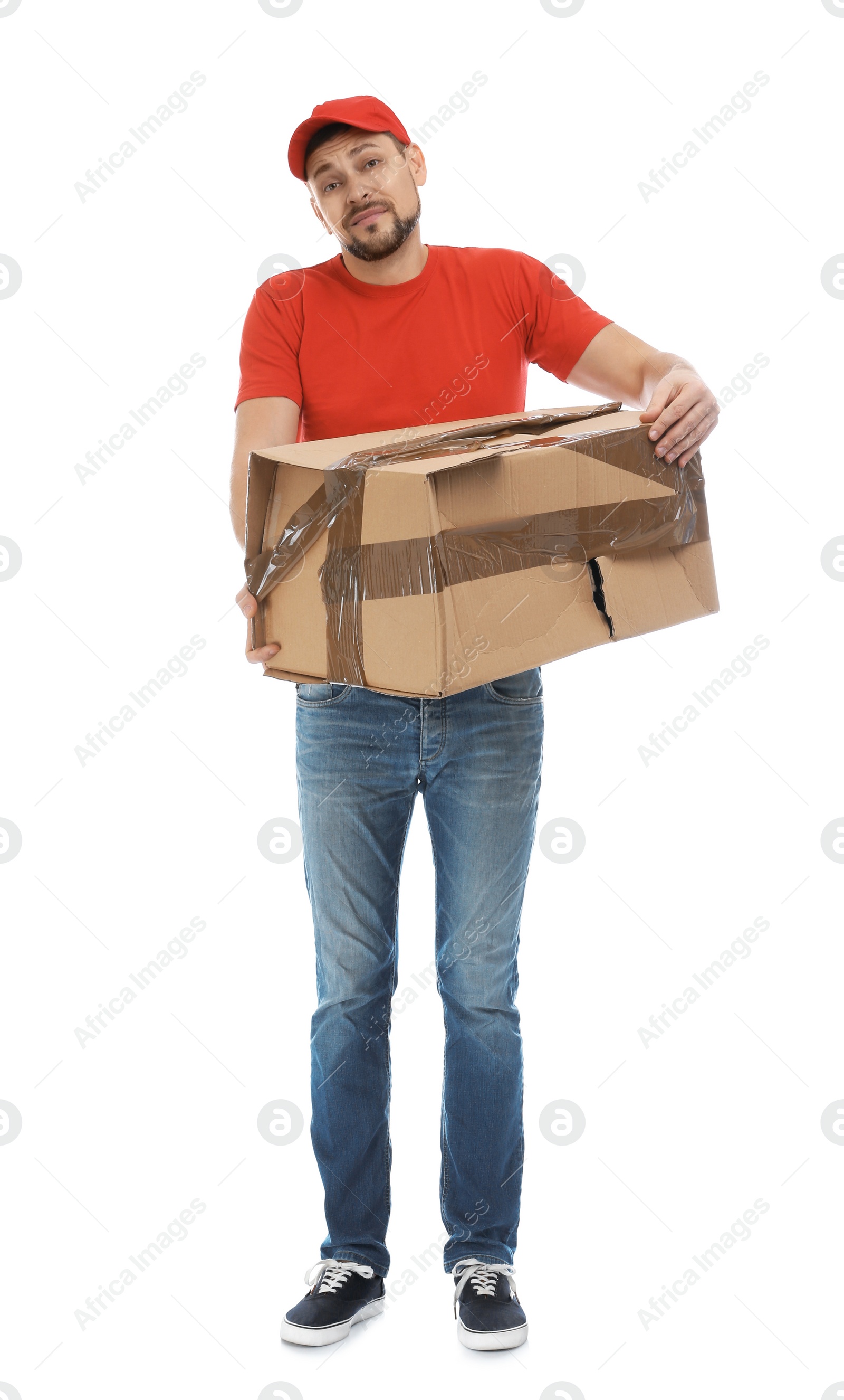 Photo of Emotional courier with damaged cardboard box on white background. Poor quality delivery service