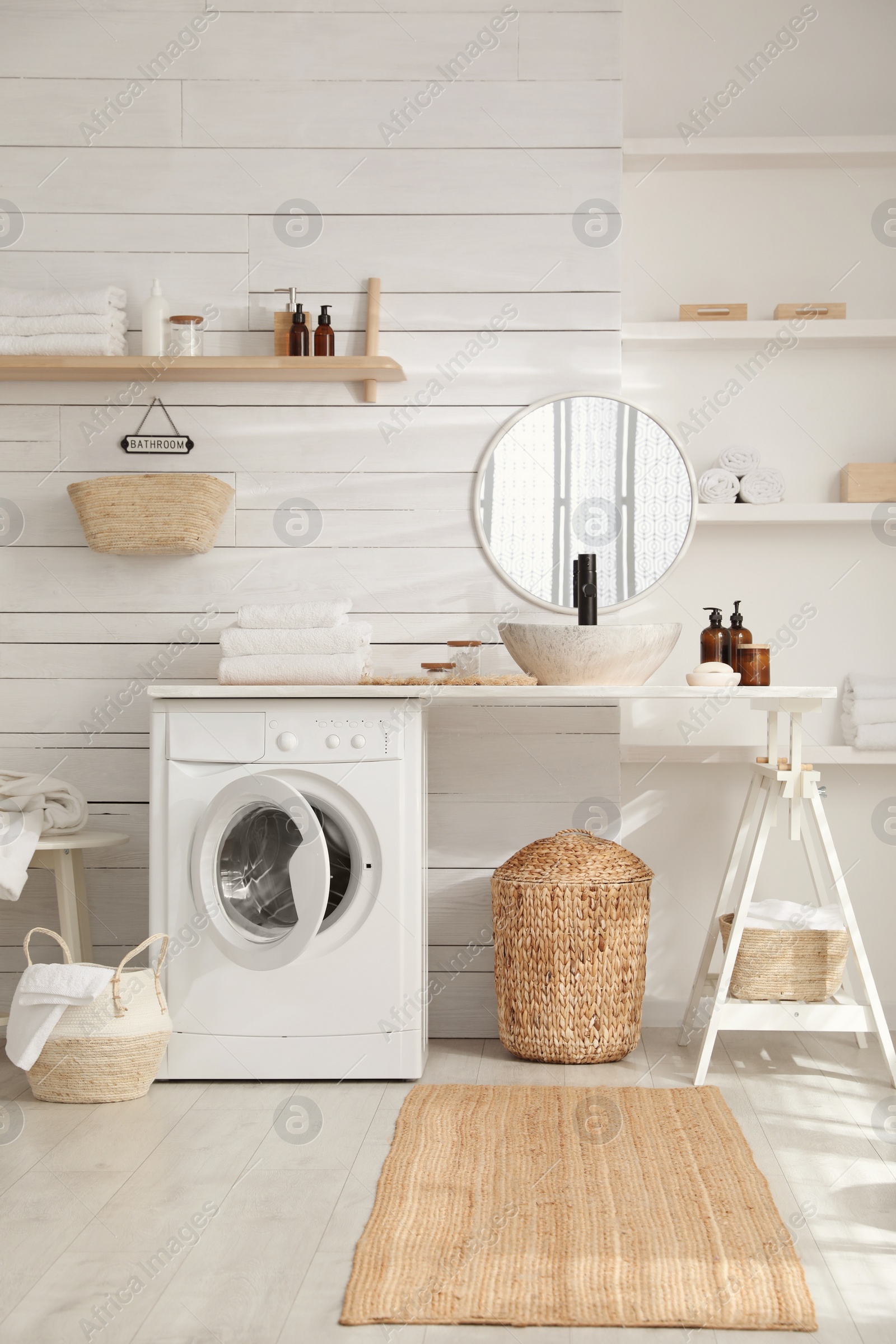 Photo of Stylish bathroom interior with modern washing machine