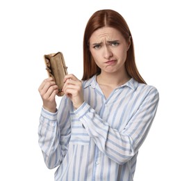 Upset woman with empty wallet on white background