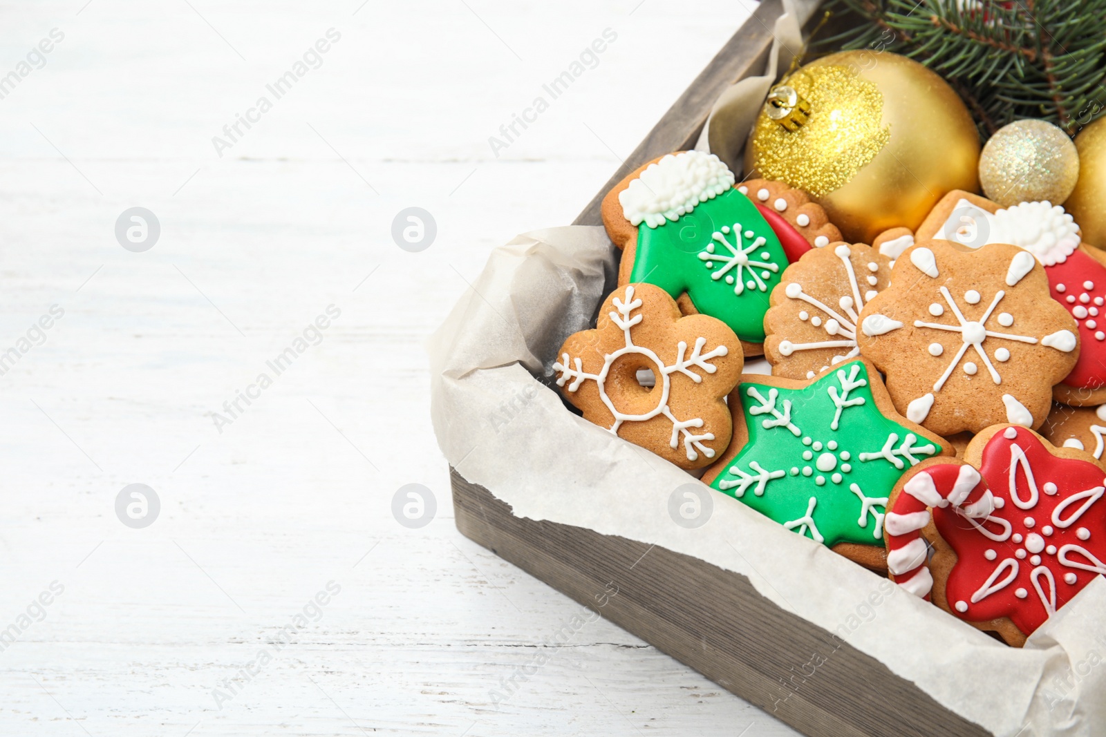 Photo of Crate with tasty homemade Christmas cookies on table