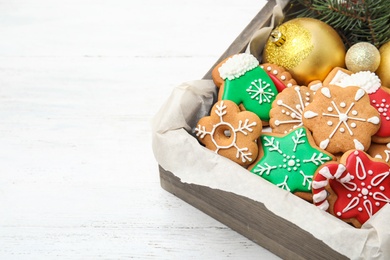 Photo of Crate with tasty homemade Christmas cookies on table