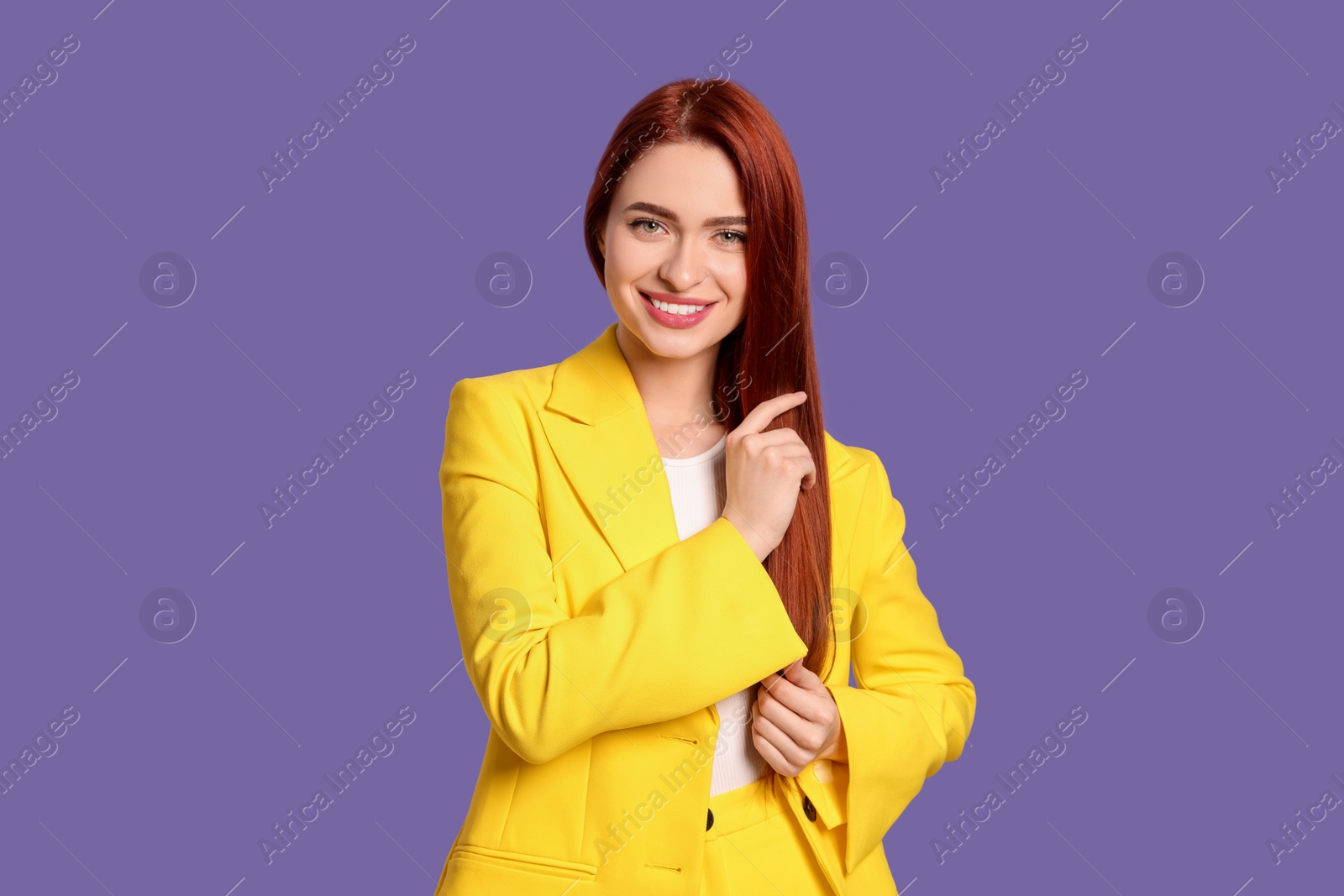 Photo of Happy woman with red dyed hair on purple background