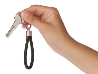 Photo of Woman holding key with black leather keychain on white background, closeup