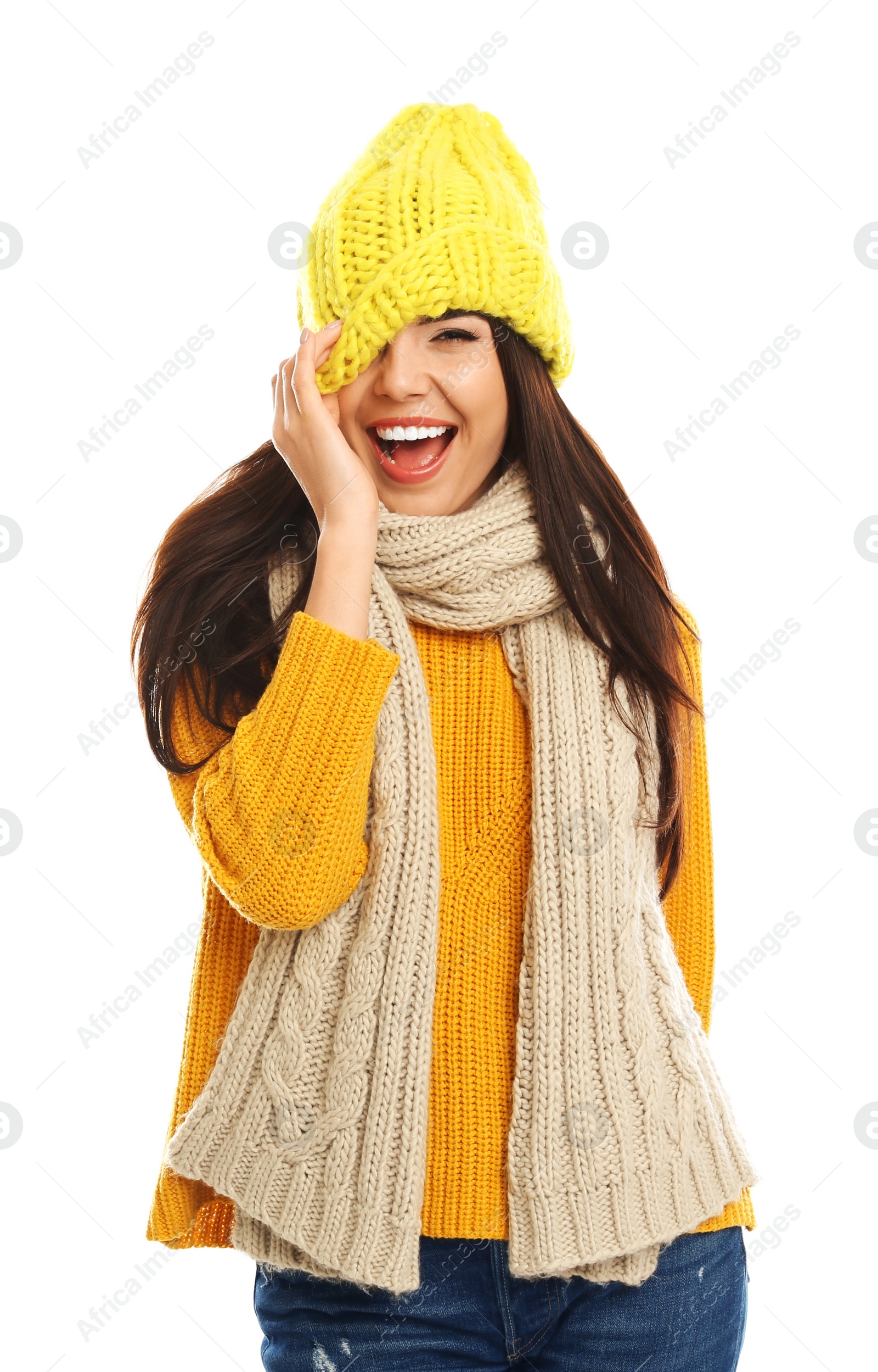 Photo of Happy young woman in warm clothes on white background. Winter vacation