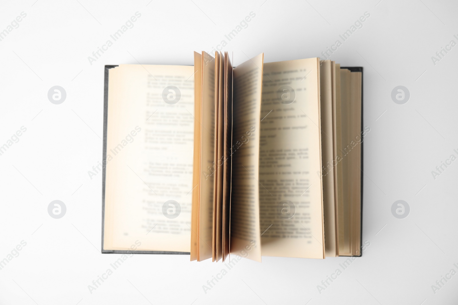 Photo of Open book on white background, top view