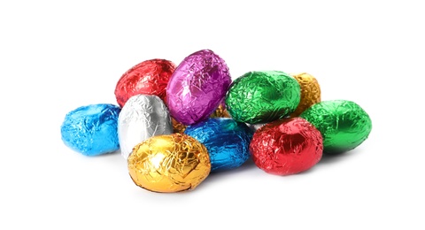 Chocolate eggs wrapped in colorful foil on white background