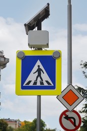 Traffic sign Pedestrian Crossing and Main road against sky outdoors