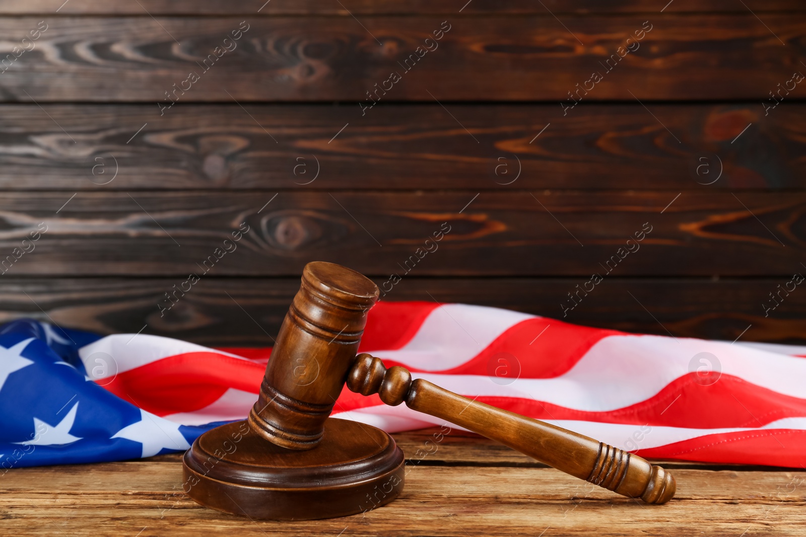 Photo of Wooden gavel and American flag on table