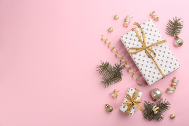 Flat lay composition with serpentine streamers and Christmas decor on pink background. Space for text