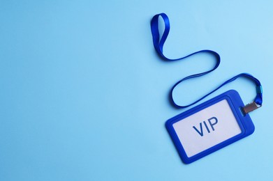 Photo of Plastic vip badge on light blue background, top view. Space for text