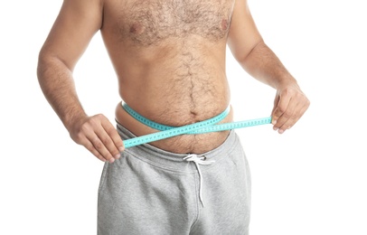 Overweight man with measuring tape on white background, closeup