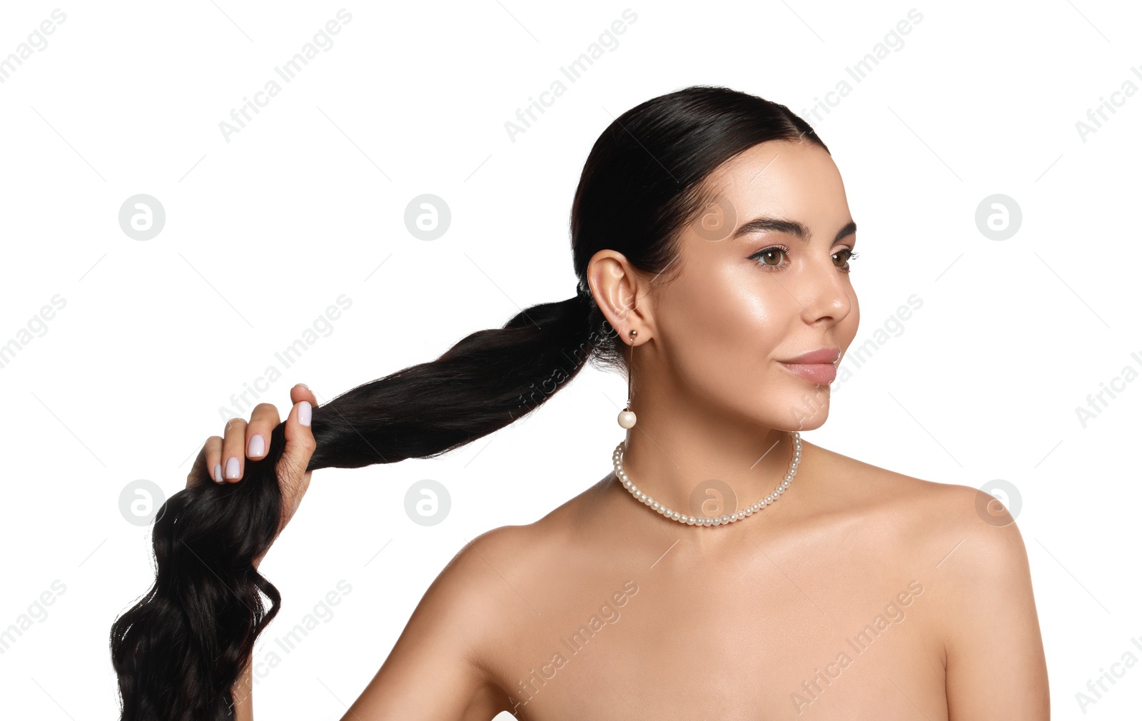 Photo of Young woman wearing elegant pearl jewelry on white background