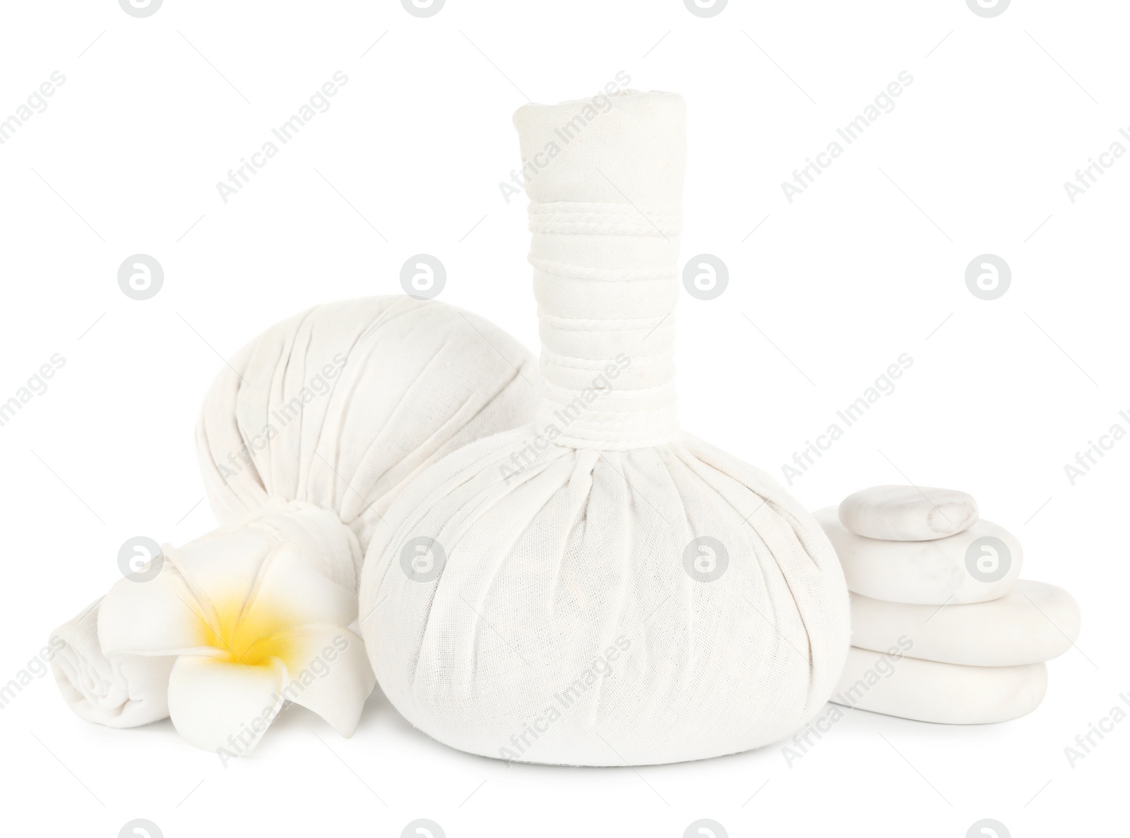 Photo of Herbal massage bags, flower and spa stones on white background