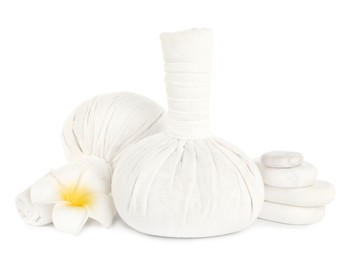 Photo of Herbal massage bags, flower and spa stones on white background