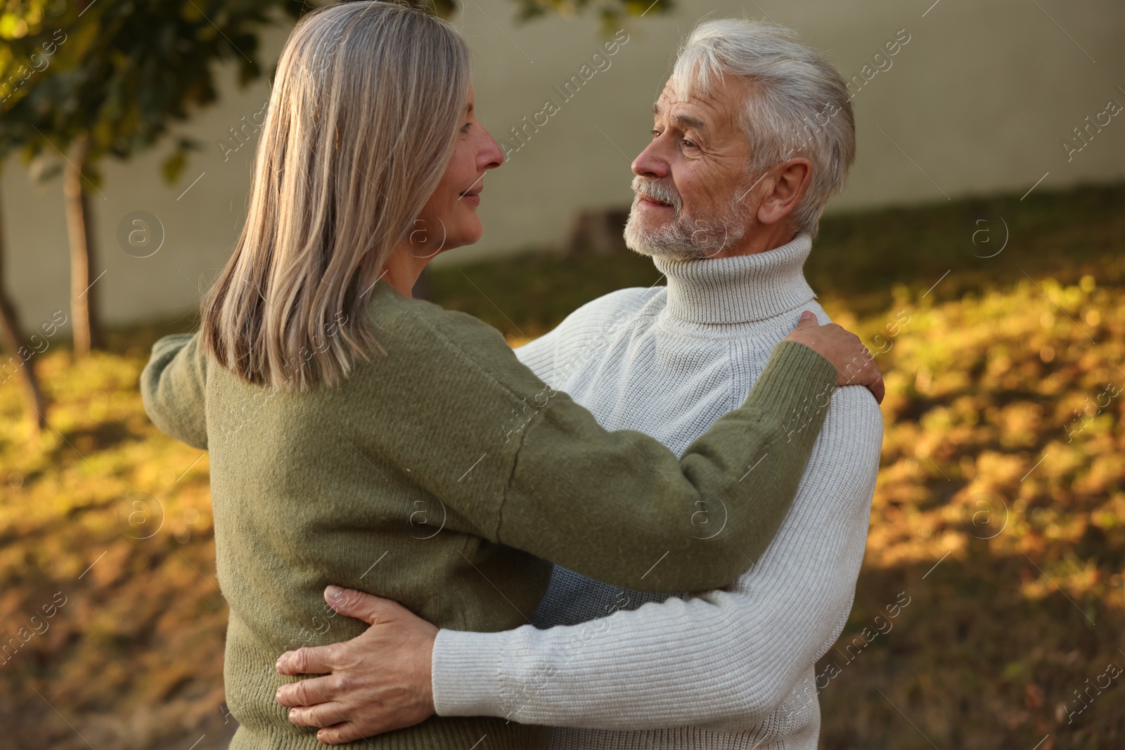 Photo of Affectionate senior couple dancing together outdoors. Romantic date