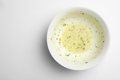 Photo of Dirty bowl with food leftovers on white background, top view