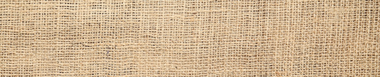 Texture of natural burlap fabric as background, top view. Banner design