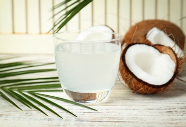 Glass of coconut water on wooden table