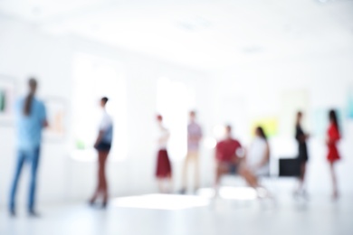 Blurred view of people at exhibition in art gallery