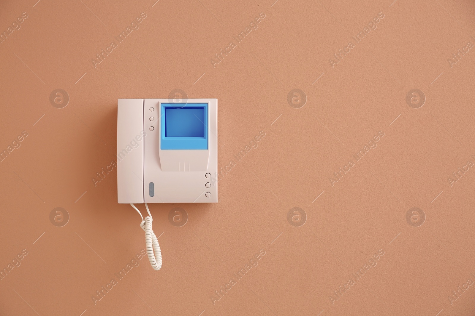 Photo of Modern intercom system with handset on beige wall, space for text