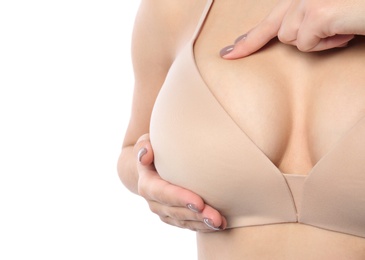 Photo of Woman checking her breast on white background, closeup. Space for text