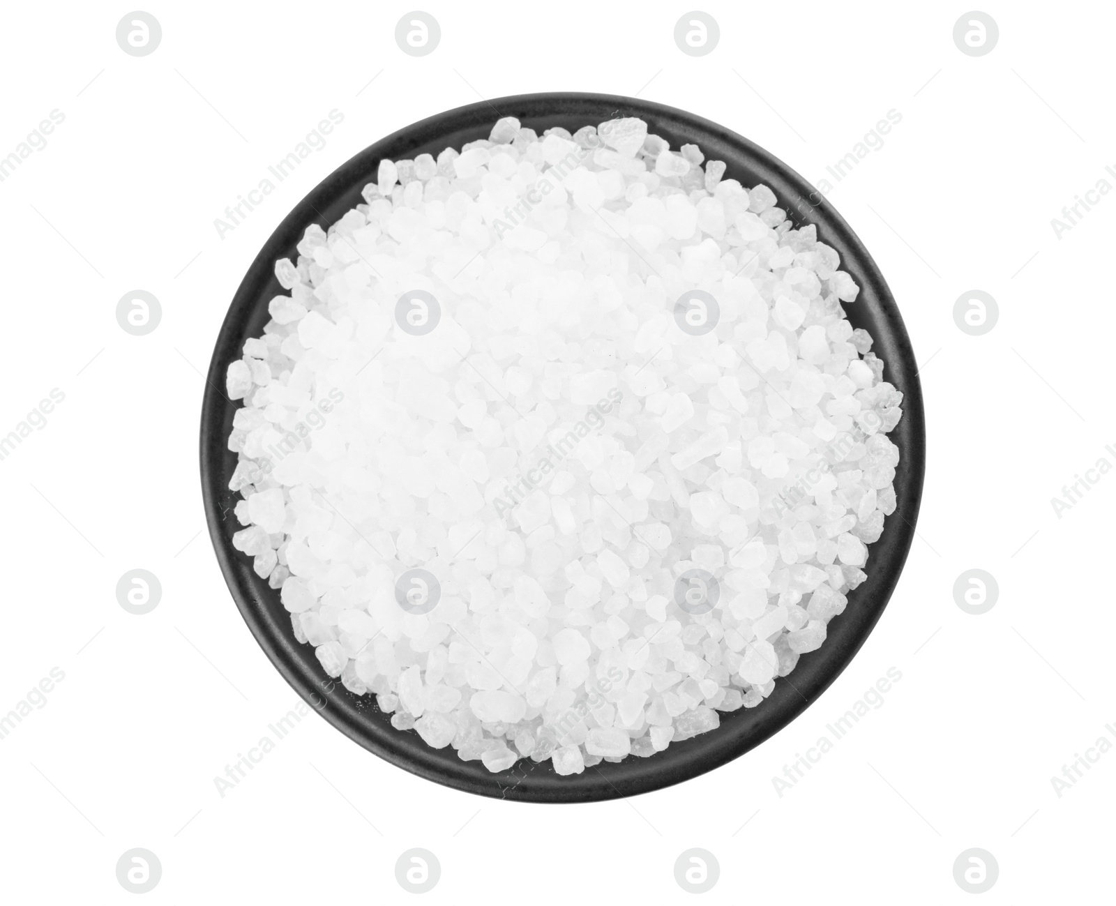 Photo of Natural sea salt in black bowl isolated on white, top view