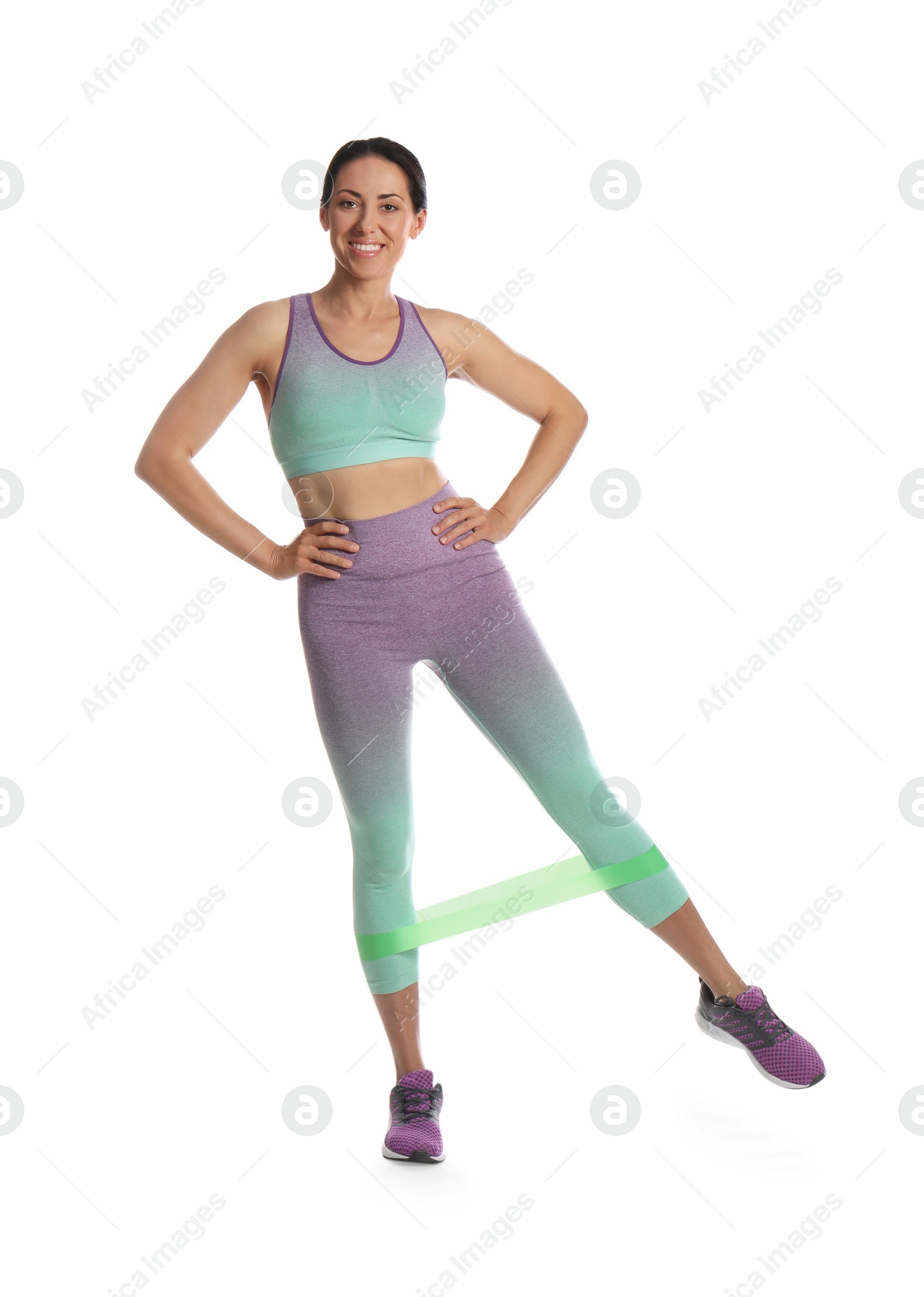 Photo of Woman doing sportive exercise with fitness elastic band on white background