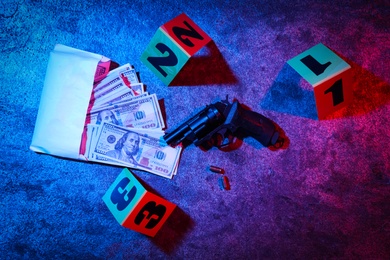 Flat lay composition with evidences on stone background, toned in red and blue. Crime scene