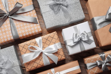 Beautiful composition with Christmas gift boxes on wooden background, top view