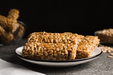 Delicious sweet kozinaki bars on grey table, closeup