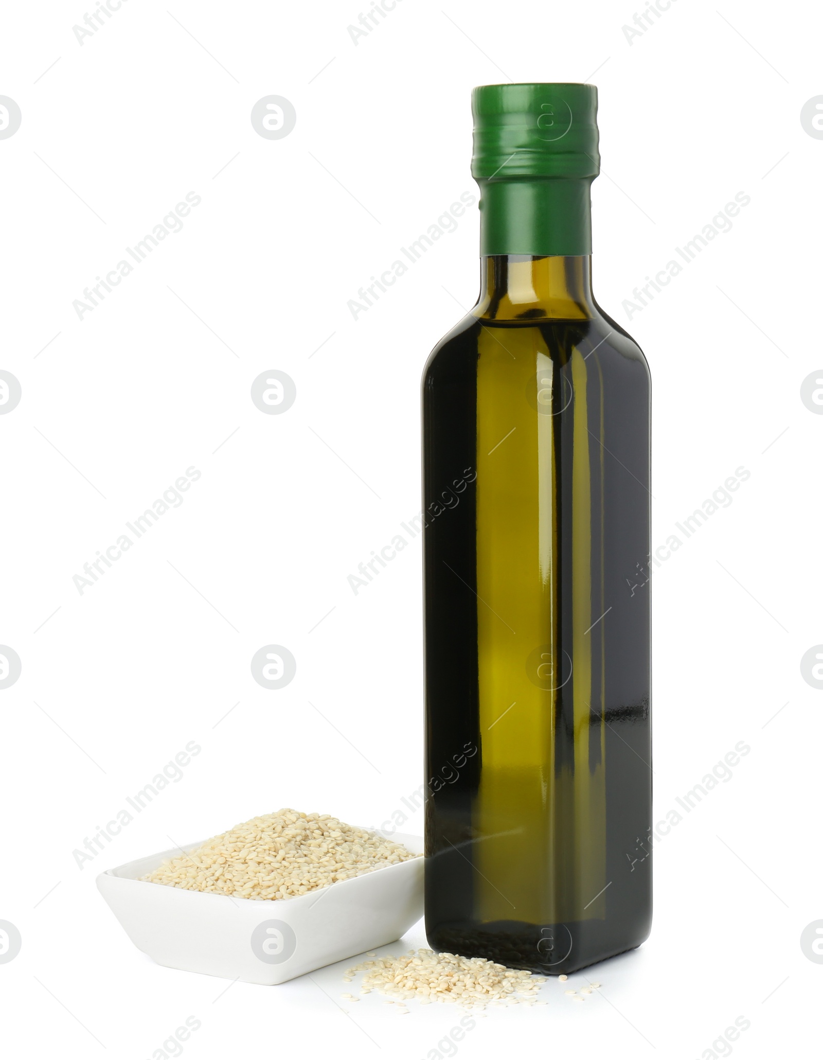 Photo of Vegetable fats. Sesame oil in glass bottle and seeds isolated on white