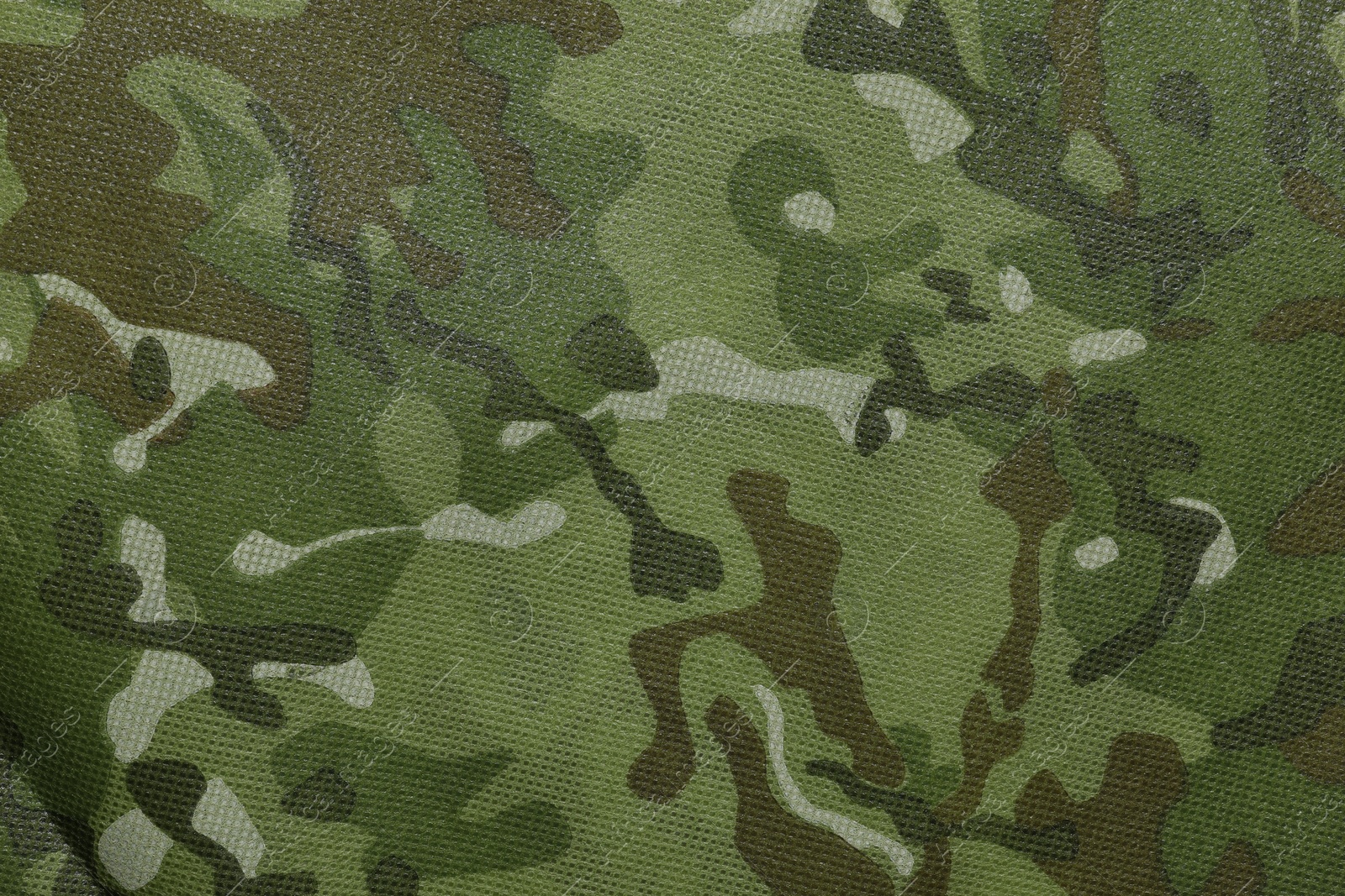 Photo of Texture of camouflage fabric as background, top view