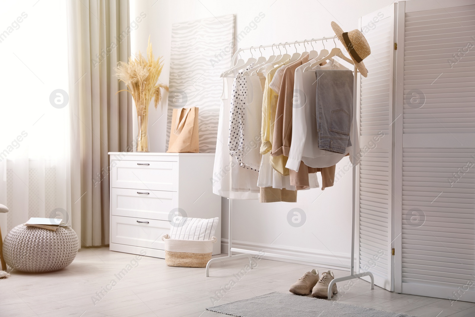 Photo of Dressing room interior with stylish white furniture