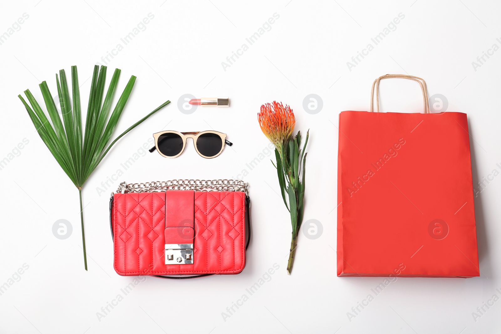 Photo of Stylish flat lay composition with shopping bag on white background