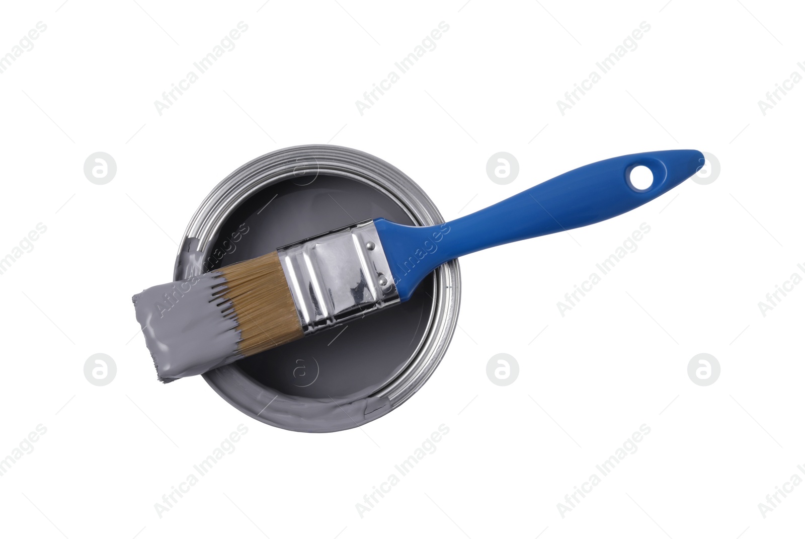 Photo of Can with grey paint and brush on white background, top view