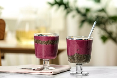 Photo of Glasses with tasty acai smoothie on table