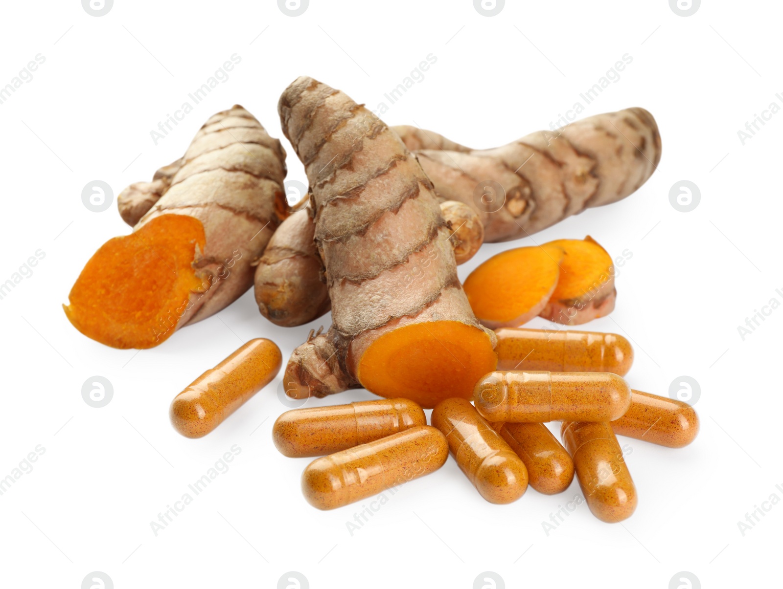 Photo of Aromatic turmeric roots and pills isolated on white