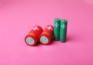 New AA and C sizes batteries on pink background
