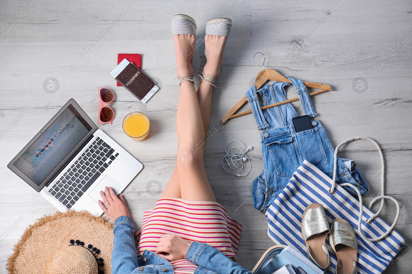 Photo of Travel blogger with laptop sitting on floor, top view