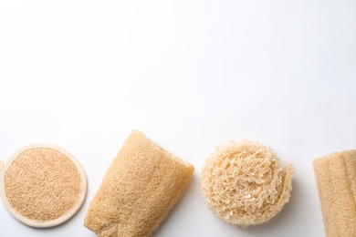Natural shower loofah sponges on white background, top view