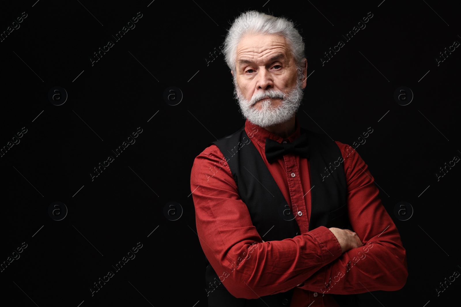 Photo of Senior man with mustache on black background, space for text