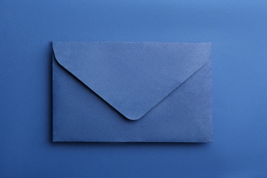 Photo of Paper envelope on blue background, top view