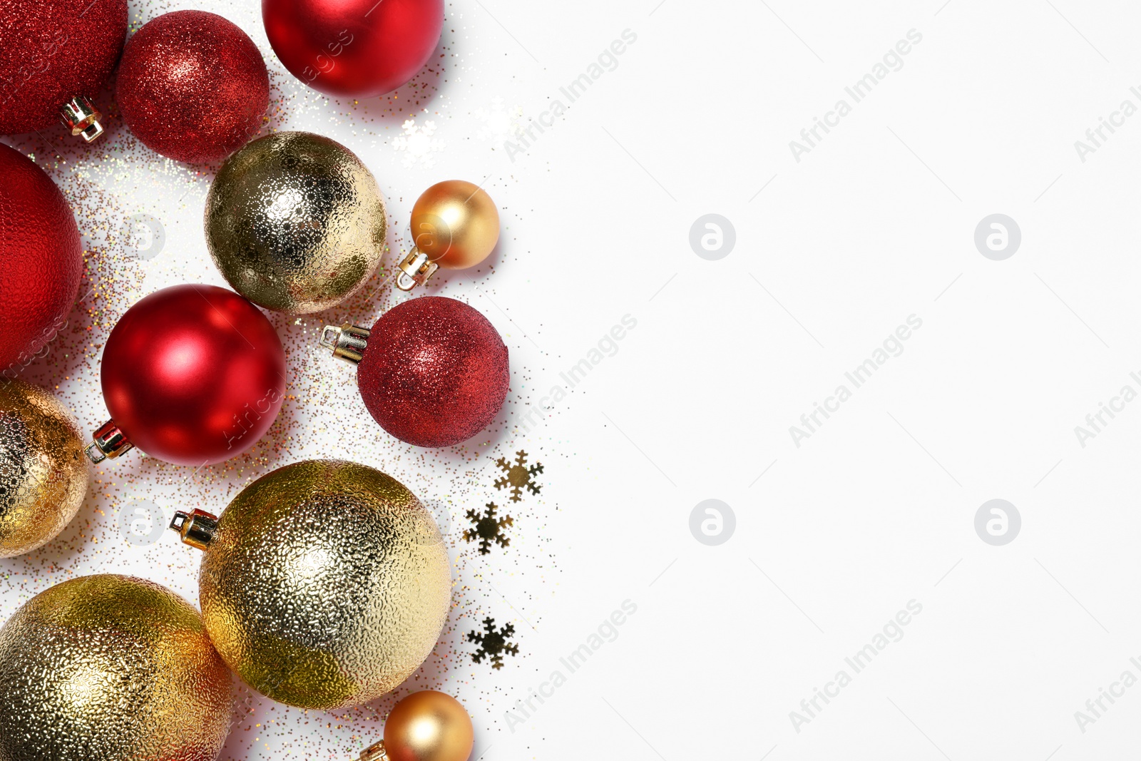 Photo of Christmas balls, confetti and glitter on white background, flat lay. Space for text