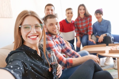 Photo of Happy friends taking selfie indoors