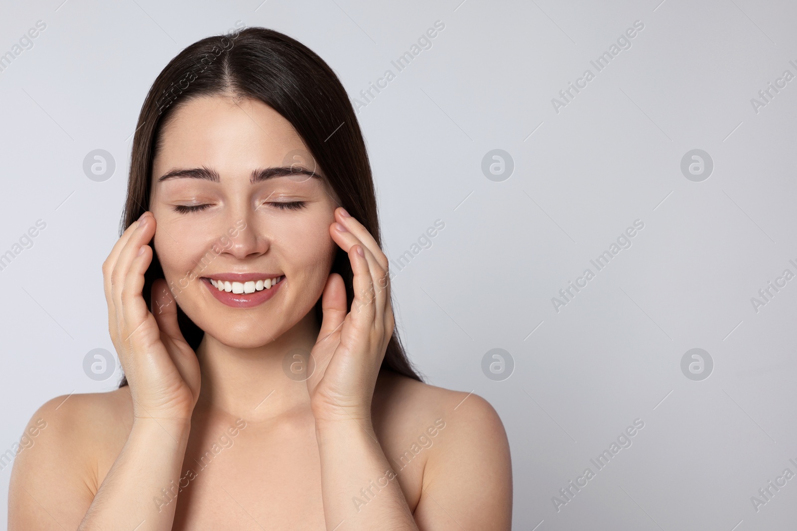 Photo of Portrait of attractive young woman on light grey background, space for text. Spa treatment