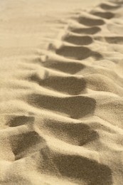 Photo of Beautiful dry beach sand as background, closeup